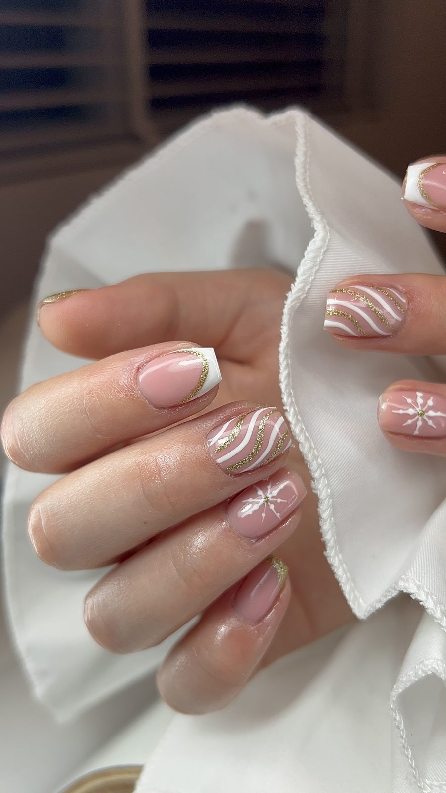 Nude nagels met witte French tips en witte swirls